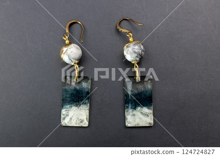 Unique earrings for women on a black background, promotional photo for an online vintage and handmade jewelry store 124724827