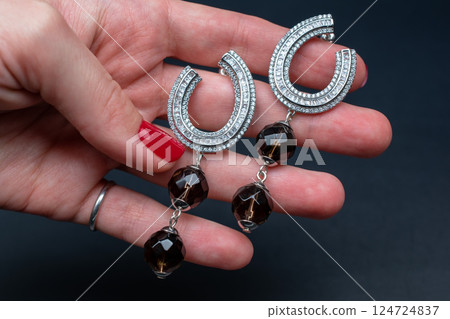 Unique earrings for women on a black background, promotional photo for an online vintage and handmade jewelry store 124724837