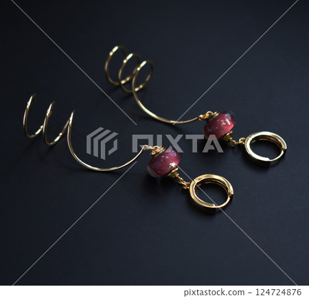 Unique earrings for women on a black background, promotional photo for an online vintage and handmade jewelry store 124724876