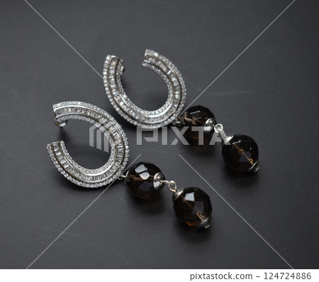 Unique earrings for women on a black background, promotional photo for an online vintage and handmade jewelry store Unique earrings for women on a black background, promotional photo for an online vintage and handmade jewelry store 124724886