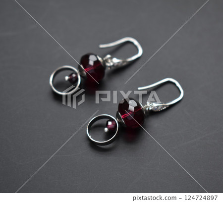Unique earrings for women on a black background, promotional photo for an online vintage and handmade jewelry store Unique earrings for women on a black background, promotional photo for an online vintage and handmade jewelry store 124724897
