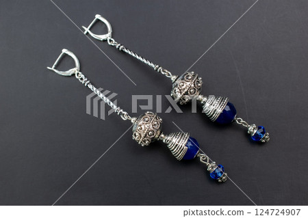 Unique earrings for women on a black background, promotional photo for an online vintage and handmade jewelry store 124724907