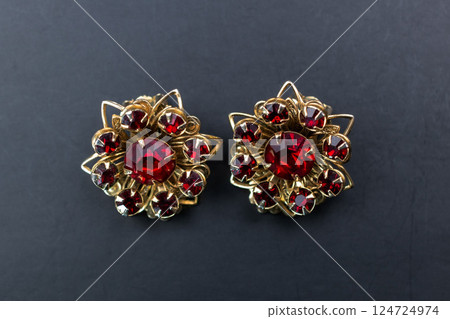 Unique earrings for women on a dark background, promotional photo for an online vintage and handmade jewelry store Unique earrings for women on a dark background, promotional photo for an online vintage and handmade jewelry store 124724974