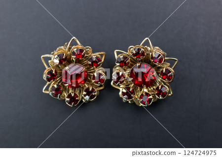 Unique earrings for women on a dark background, promotional photo for an online vintage and handmade jewelry store Unique earrings for women on a dark background, promotional photo for an online vintage and handmade jewelry store 124724975