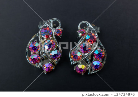 Unique earrings for women on a dark background, promotional photo for an online vintage and handmade jewelry store Unique earrings for women on a dark background, promotional photo for an online vintage and handmade jewelry store 124724976