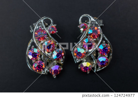 Unique earrings for women on a dark background, promotional photo for an online vintage and handmade jewelry store Unique earrings for women on a dark background, promotional photo for an online vintage and handmade jewelry store 124724977