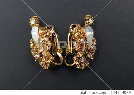 Unique earrings for women on a dark background, promotional photo for an online vintage and handmade jewelry store 124724979