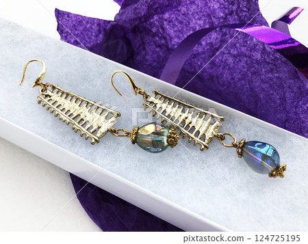 Unique earrings for women on a purple background, promotional photo for an online vintage and handmade jewelry store 124725195