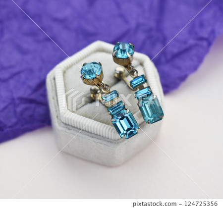 Unique earrings for women on a purple background, promotional photo for an online vintage and handmade jewelry store 124725356