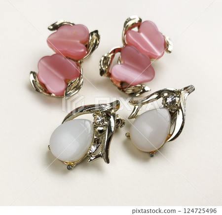 Unique earrings for women on a white background, promotional photo for an online vintage and handmade jewelry store Unique earrings for women on a white background, promotional photo for an online vintage and handmade jewelry store 124725496