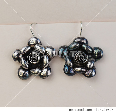 Unique earrings for women on a white background, promotional photo for an online vintage and handmade jewelry store Unique earrings for women on a white background, promotional photo for an online vintage and handmade jewelry store 124725607