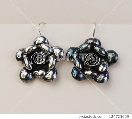Unique earrings for women on a white background, promotional photo for an online vintage and handmade jewelry store Unique earrings for women on a white background, promotional photo for an online vintage and handmade jewelry store 124725609