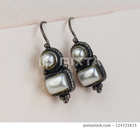 Unique earrings for women on a white background, promotional photo for an online vintage and handmade jewelry store Unique earrings for women on a white background, promotional photo for an online vintage and handmade jewelry store 124725615
