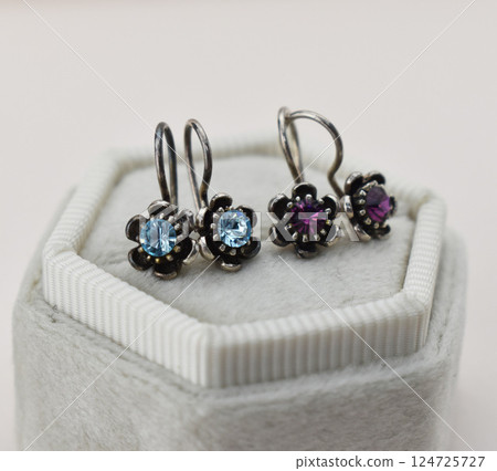 Unique earrings for women on a white background, promotional photo for an online vintage and handmade jewelry store Unique earrings for women on a white background, promotional photo for an online vintage and handmade jewelry store 124725727