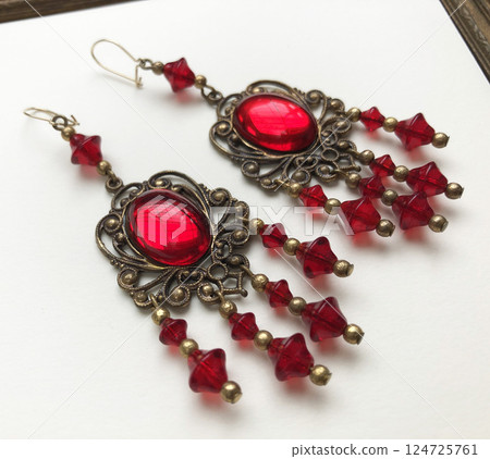 Unique earrings for women on a white background, promotional photo for an online vintage and handmade jewelry store Unique earrings for women on a white background, promotional photo for an online vintage and handmade jewelry store 124725761