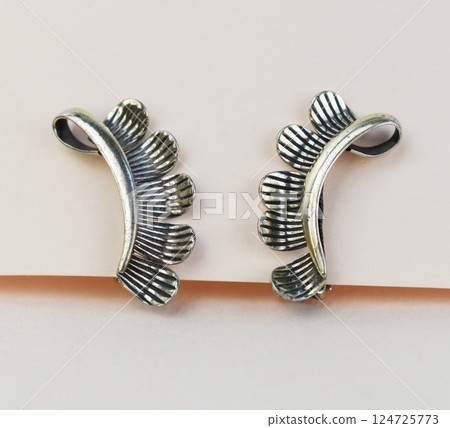 Unique earrings for women on a white background, promotional photo for an online vintage and handmade jewelry store Unique earrings for women on a white background, promotional photo for an online vintage and handmade jewelry store 124725773