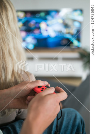 Hands using game controller. Playing video games 124726043
