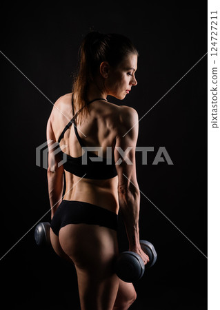Happy woman do exercise with dumbbell. Smiling female, fitness workout. Healthy lifestyle concept. Happy woman do exercise with dumbbell. Smiling female, fitness workout. Healthy lifestyle concept. 124727211