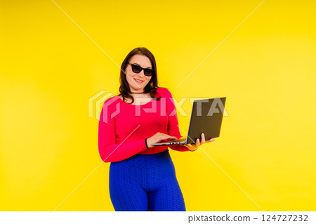 Full length photo of a young smiling fat overweight woman wearing sportswear Full length photo of a young smiling fat overweight woman wearing sportswear 124727232