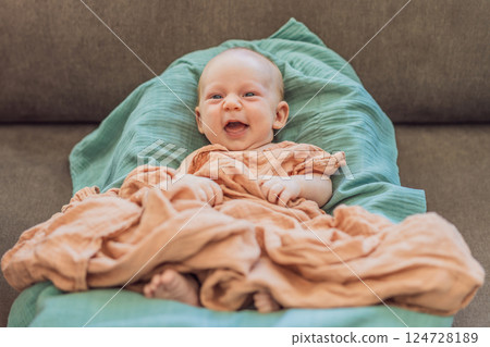 Newborn baby comfortably resting in a cozy baby nest. Safe and peaceful sleep concept for infants Newborn baby comfortably resting in a cozy baby nest. Safe and peaceful sleep concept for infants 124728189