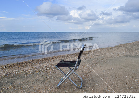 Folding chair by the sea. Convenience to the tourist. Rest by the sea. Folding chair by the sea. Convenience to the tourist. Rest by the sea. 124728332