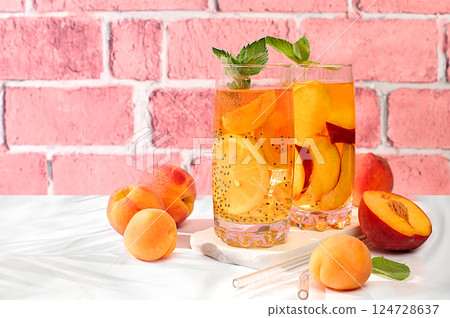 Diet vegan cocktail with chia seeds, lime, lemon, mint and apricots. Detox diet and weight loss concept, summer party and healthy lifestyle advertising. Menu for cafe and restaurant. Diet vegan cocktail with chia seeds, lime, lemon, mint and apricots. Detox diet and weight loss concept, summer party and healthy lifestyle advertising. Menu for cafe and restaurant. 124728637