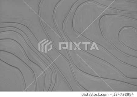 Plaster wall with volumetric relief surface with convex wavy lines, gray gypsum texture panel. 124728994