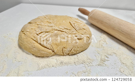 Fresh Dough Ready for Baking with a Rolling Pin and Flour Dusting 124729058