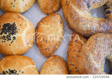 A Variety of Assorted Bakery Breads That Includes Delicious Bagels and Fresh Rolls A Variety of Assorted Bakery Breads That Includes Delicious Bagels and Fresh Rolls 124729348