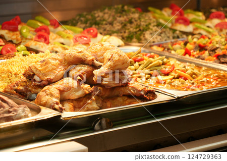 Indulge in Delicious Fried Chicken accompanied by Colorful Sides at a Charming Buffet Indulge in Delicious Fried Chicken accompanied by Colorful Sides at a Charming Buffet 124729363