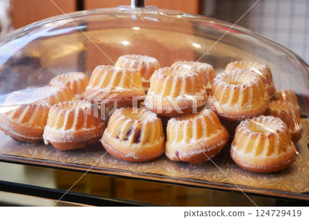 A mouthwatering selection of Delicious Mini Bundt Cakes Displayed Under a Beautiful Glass Dome A mouthwatering selection of Delicious Mini Bundt Cakes Displayed Under a Beautiful Glass Dome 124729419