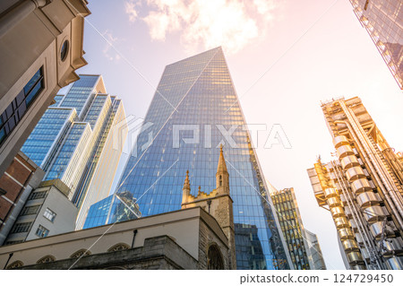 St Andrew Undershaft Church stands in front of towering modern skyscrapers in the heart of London's financial district, showcasing the blend of history and contemporary architecture. St Andrew Undershaft Church stands in front of towering modern skyscrapers in the heart of London's financial district, showcasing the blend of history and contemporary architecture. 124729450