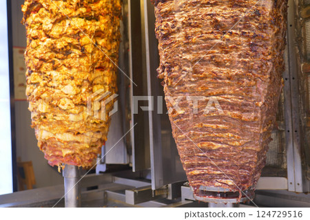 Delicious Shawarma is Rotating on Skewers in a Restaurant, a Culinary Delight to Enjoy Delicious Shawarma is Rotating on Skewers in a Restaurant, a Culinary Delight to Enjoy 124729516
