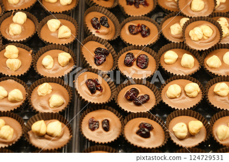 Delightful Assorted Chocolate Cups adorned with a variety of Toppings for every palate 124729531