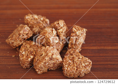 Granola squares arranged on a wooden surface for healthy snacking Granola squares arranged on a wooden surface for healthy snacking 124729612