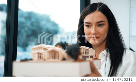 Skilled caucasian architect lift house model to check mistake point. Immaculate. 124730211