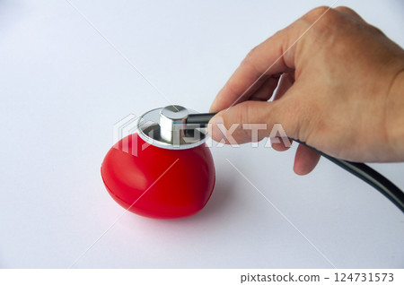 Top view of hand holding stethoscope and a red heart shaped with customizable space for text. Medical and health concept Top view of hand holding stethoscope and a red heart shaped with customizable space for text. Medical and health concept 124731573