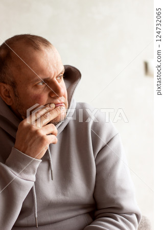 Portrait of a brown-eyed forty-seven year old sad, thoughtful man looking away Portrait of a brown-eyed forty-seven year old sad, thoughtful man looking away 124732065