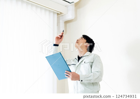 Workers inspecting air conditioners 124734931