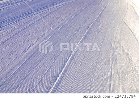 The pattern of snow after being compacted by a snow groomer on a ski slope The pattern of snow after being compacted by a snow groomer on a ski slope 124735794