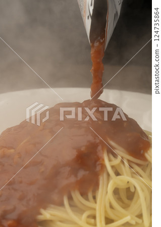 Pour retort pasta sauce over pasta Pour retort pasta sauce over pasta 124735864