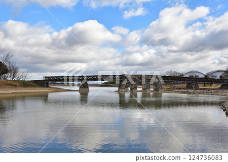 Stone bridge floating on clear pond water 124736083