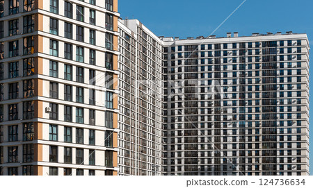 Building with modern architecture. Tall condominium block with window facade in urban neighborhood, 124736634