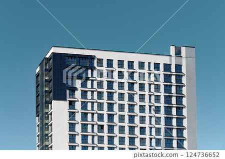 Building in downtown city. Tall modern highrise with office and residential accommodation, facade 124736652