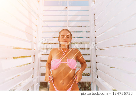 Beach Shower Woman Summer: Outdoor rinsing after sunbathing, refreshing, relaxation. Beach Shower Woman Summer: Outdoor rinsing after sunbathing, refreshing, relaxation. 124736733