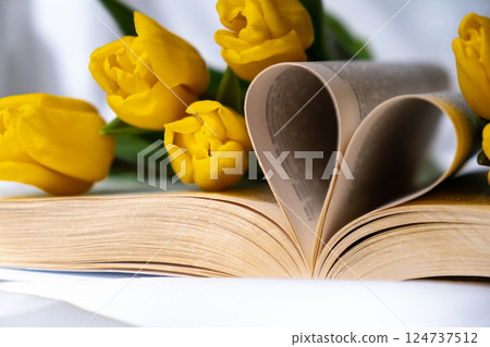 Heart shaped book pages for romantic love greeting card template. Fresh bouquet of yellow tulip flowers. Gift present idea for holiday birthday 8 March Mother's Day Valentine's day Women's Day Heart shaped book pages for romantic love greeting card template. Fresh bouquet of yellow tulip flowers. Gift present idea for holiday birthday 8 March Mother's Day Valentine's day Women's Day 124737512