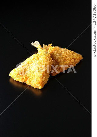 Fried horse mackerel photographed against a black background Fried horse mackerel photographed against a black background 124738060