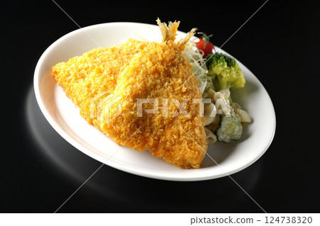 Fried horse mackerel photographed against a black background 124738320