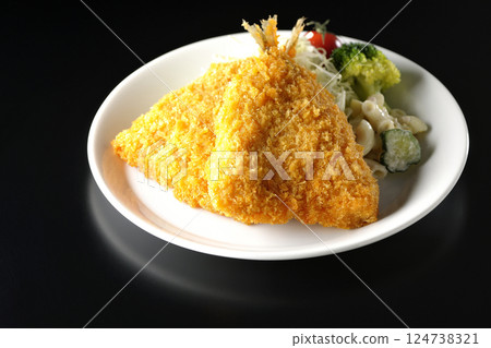 Fried horse mackerel photographed against a black background 124738321