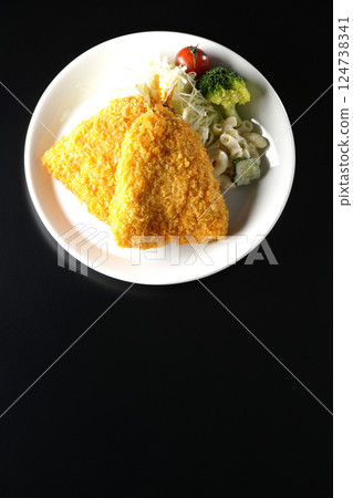 Fried horse mackerel photographed against a black background 124738341